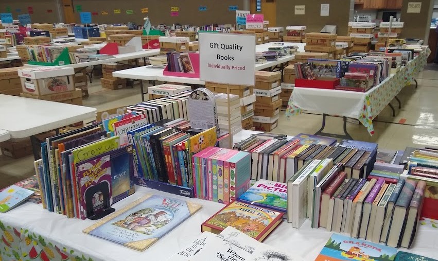 Book sale tables sorted by genre