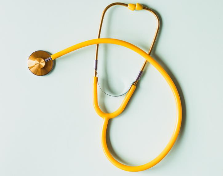 yellow stethescope to represent health and wellness